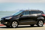 Picture of a driving 2016 Ford Escape in Shadow Black from a side perspective