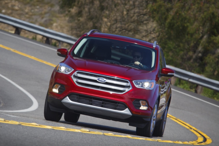 Picture of a driving 2017 Ford Escape Titanium in Ruby Red Metallic Tinted Clearcoat from a frontal perspective