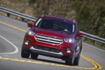 Picture of a driving 2018 Ford Escape Titanium in Ruby Red Metallic Tinted Clearcoat from a frontal perspective