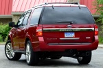 Picture of a 2015 Ford Expedition Platinum in Ruby Red Metallic Tinted Clearcoat from a rear left perspective