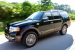 Picture of a driving 2015 Ford Expedition King Ranch in Green Gem Metallic from a front left perspective