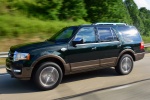 Picture of a driving 2015 Ford Expedition King Ranch in Green Gem Metallic from a front left three-quarter perspective