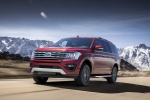 Picture of a driving 2019 Ford Expedition XLT FX4 in Ruby Red Metallic Tinted Clearcoat from a front left three-quarter perspective