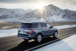 Picture of a driving 2019 Ford Expedition Platinum in Blue Metallic from a rear right three-quarter perspective