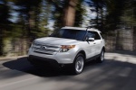 Picture of a driving 2014 Ford Explorer Limited 4WD in White from a front left three-quarter perspective