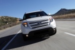 Picture of a driving 2014 Ford Explorer Limited 4WD in White from a frontal perspective
