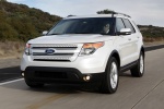 Picture of a driving 2014 Ford Explorer Limited 4WD in White from a front left perspective