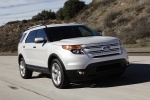 Picture of a driving 2014 Ford Explorer Limited 4WD in Ingot Silver Metallic from a front right perspective