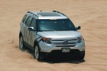 Picture of a driving 2014 Ford Explorer Limited 4WD in Ingot Silver Metallic from a front right top perspective