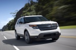 Picture of a driving 2014 Ford Explorer Sport 4WD in White Platinum Metallic Tri-Coat from a front right perspective