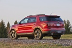 Picture of a 2014 Ford Explorer Sport 4WD in Ruby Red Metallic Tinted Clearcoat from a rear left perspective