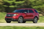 Picture of a driving 2014 Ford Explorer Sport 4WD in Ruby Red Metallic Tinted Clearcoat from a front left three-quarter perspective