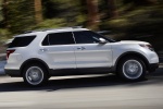 Picture of a driving 2015 Ford Explorer Limited 4WD in White from a right side perspective