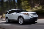 Picture of a driving 2015 Ford Explorer Limited 4WD in White from a front right three-quarter perspective