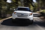 Picture of a driving 2015 Ford Explorer Limited 4WD in White from a frontal perspective