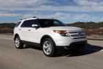 Picture of a driving 2015 Ford Explorer Limited 4WD in White from a front right three-quarter perspective
