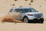 Picture of a driving 2015 Ford Explorer Limited 4WD in Ingot Silver Metallic from a front right three-quarter perspective