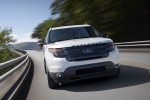 Picture of a driving 2015 Ford Explorer Sport 4WD in White Platinum Metallic Tri-Coat from a frontal perspective