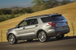 Picture of a driving 2016 Ford Explorer Sport 4WD in Magnetic Metallic from a rear left three-quarter perspective