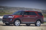 Picture of a driving 2016 Ford Explorer Limited 4WD in Bronze Fire Metallic Tinted Clearcoat from a front left three-quarter perspective