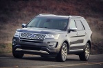 Picture of a driving 2017 Ford Explorer Platinum 4WD in Magnetic Metallic from a front left perspective