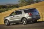 Picture of a driving 2018 Ford Explorer Sport 4WD in Magnetic Metallic from a rear left three-quarter perspective