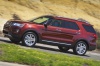 Picture of a driving 2019 Ford Explorer Limited 4WD from a side perspective
