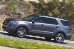 Picture of a driving 2019 Ford Explorer Sport 4WD in Magnetic Metallic from a side perspective