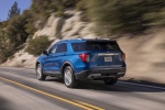 Picture of a driving 2020 Ford Explorer Limited in Atlas Blue Metallic from a rear left perspective