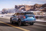 Picture of a driving 2020 Ford Explorer ST EcoBoost 4WD in Atlas Blue Metallic from a rear left perspective