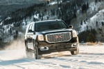 Picture of a driving 2018 GMC Yukon Denali in Onyx Black from a front right perspective
