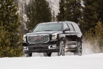 Picture of a driving 2018 GMC Yukon Denali in Onyx Black from a front left three-quarter perspective
