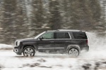 Picture of a driving 2018 GMC Yukon Denali in Onyx Black from a left side perspective