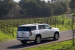 Picture of a driving 2018 GMC Yukon SLT in Quicksilver Metallic from a rear right three-quarter perspective
