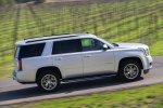 Picture of a driving 2018 GMC Yukon SLT in Quicksilver Metallic from a side perspective
