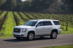 Picture of a driving 2018 GMC Yukon SLT in Quicksilver Metallic from a front left three-quarter perspective