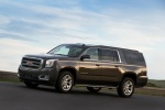 Picture of a driving 2018 GMC Yukon XL Denali in Iridium Metallic from a left side perspective