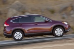 Picture of a driving 2014 Honda CR-V EX-L AWD in Basque Red Pearl II from a side perspective