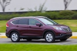 Picture of a driving 2014 Honda CR-V EX-L AWD in Basque Red Pearl II from a front right three-quarter perspective