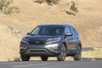Picture of a driving 2015 Honda CR-V Touring in Modern Steel Metallic from a front left perspective