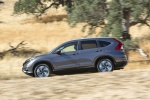 Picture of a driving 2015 Honda CR-V Touring in Modern Steel Metallic from a side perspective