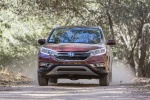 Picture of a driving 2015 Honda CR-V Touring AWD in Basque Red Pearl II from a frontal perspective