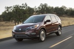 Picture of a driving 2015 Honda CR-V Touring AWD in Basque Red Pearl II from a front left three-quarter perspective