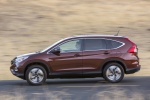 Picture of a driving 2015 Honda CR-V Touring AWD in Basque Red Pearl II from a side perspective