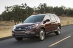 Picture of a driving 2016 Honda CR-V Touring AWD in Basque Red Pearl II from a front left three-quarter perspective