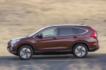 Picture of a driving 2016 Honda CR-V Touring AWD in Basque Red Pearl II from a side perspective