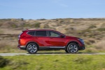 Picture of a driving 2017 Honda CR-V Touring AWD in Molten Lava Pearl from a right side perspective