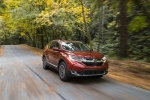 Picture of a driving 2017 Honda CR-V Touring AWD in Molten Lava Pearl from a front right perspective