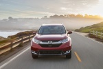 Picture of a driving 2017 Honda CR-V Touring AWD in Molten Lava Pearl from a frontal perspective