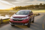 Picture of a driving 2017 Honda CR-V Touring AWD in Molten Lava Pearl from a front left perspective